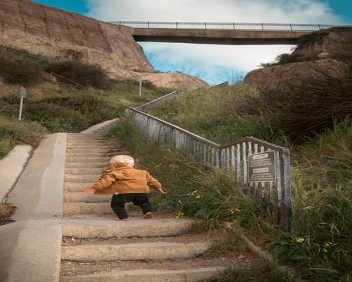 A person climbing steps representing small steps towards wellness